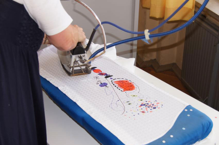 Ironing the finished GERMENS shirt before packing it away