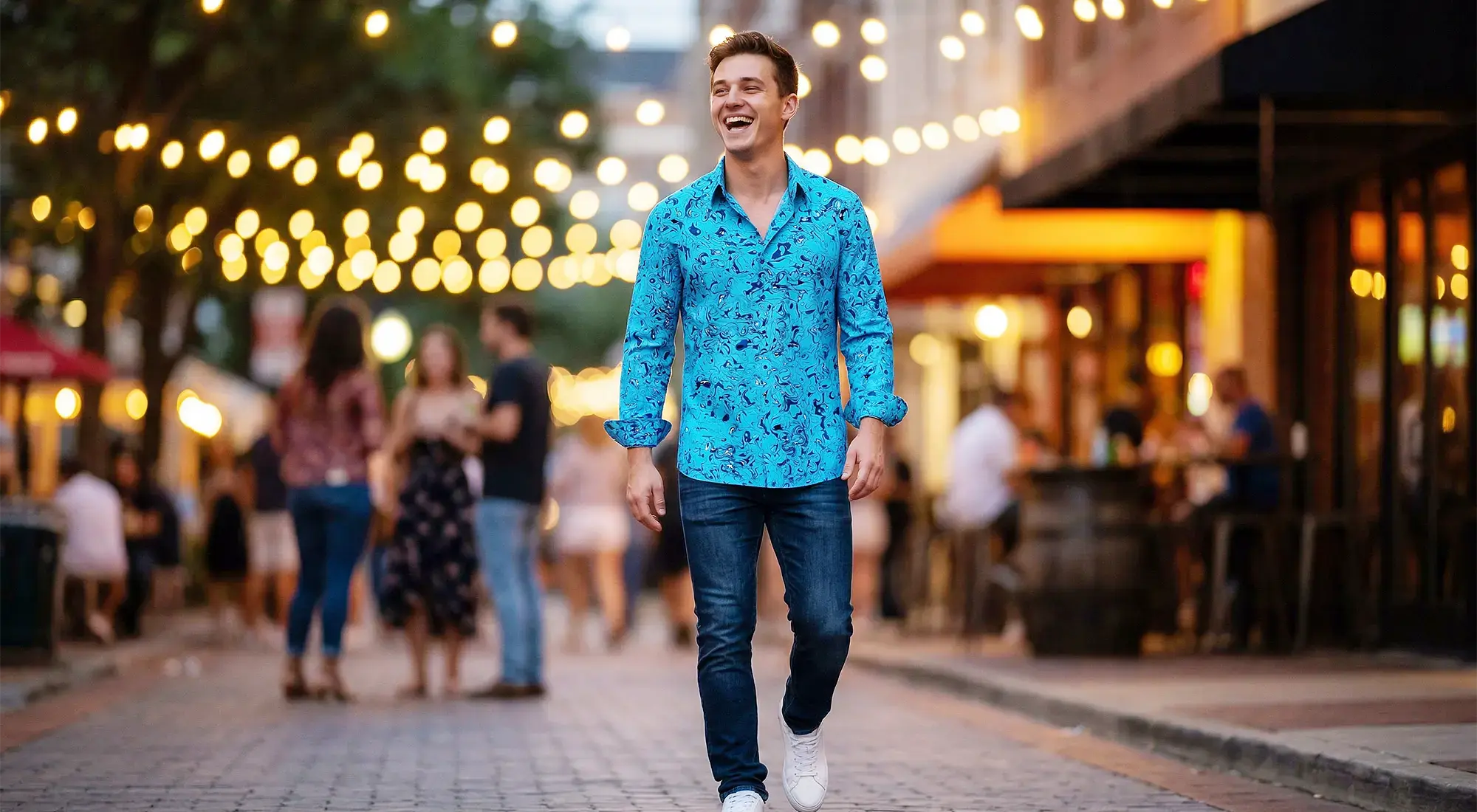 A young man in his mid-20s wears the light blue GERMENS shirt GRAVUR BLUE.