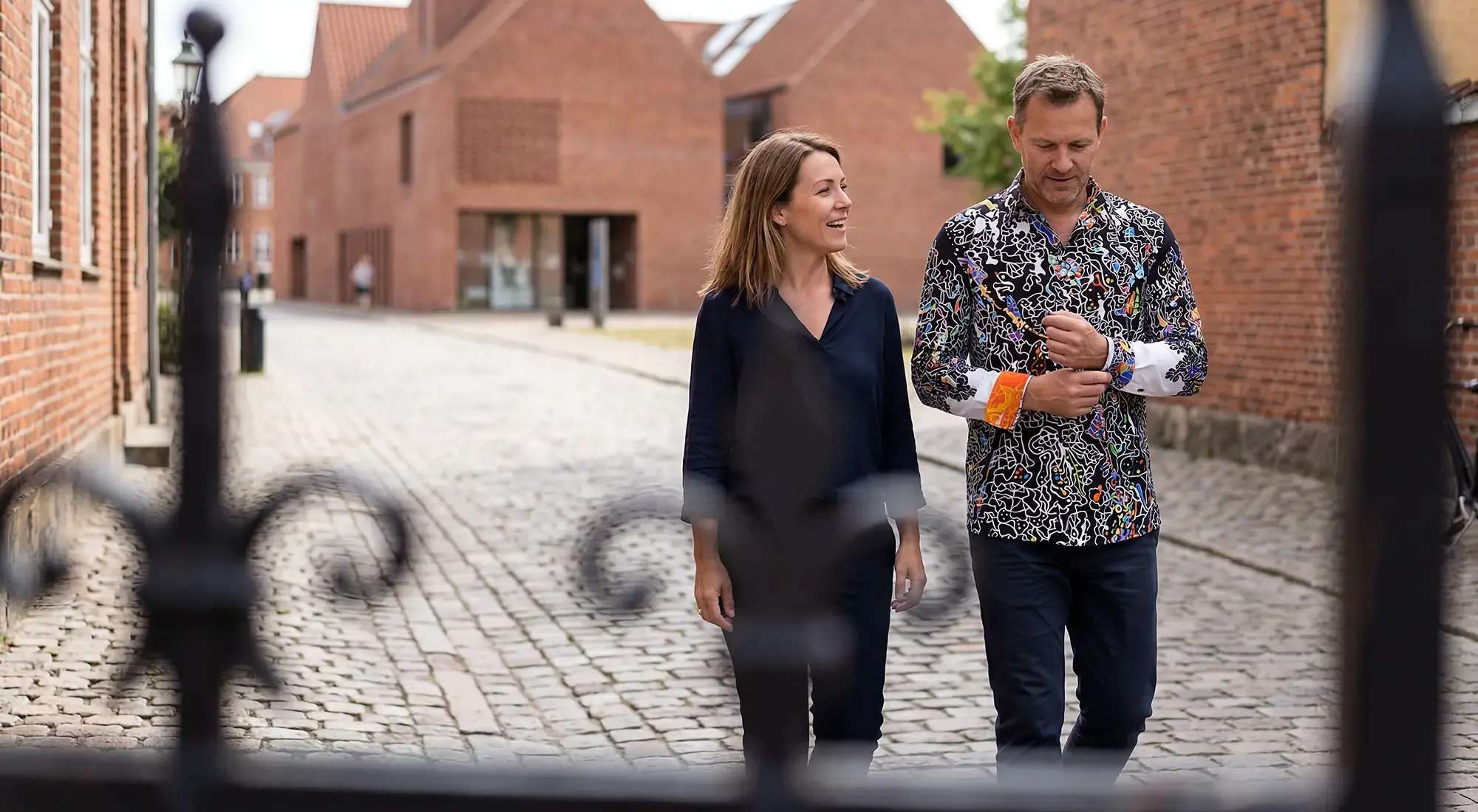 A married couple strolls through the Danish city of Odense. The man wears the eye-catching GERMENS DÉJÀ-VU shirt.