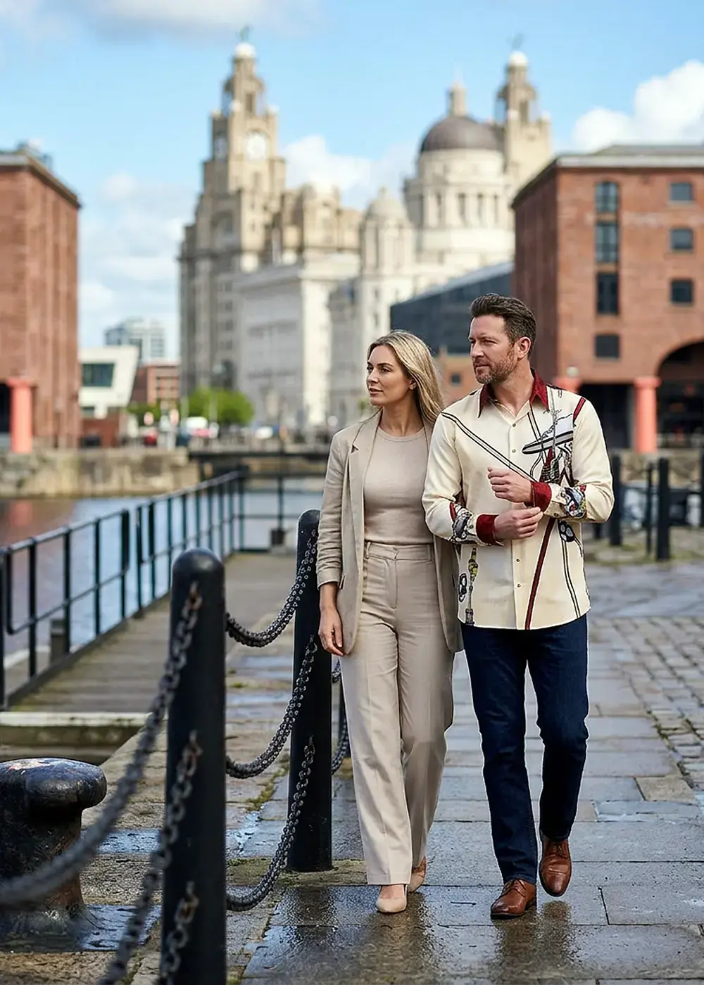 A married couple visits Liverpool. The man is wearing the LEIDENSCHAFT soccer jersey from GERMENS.