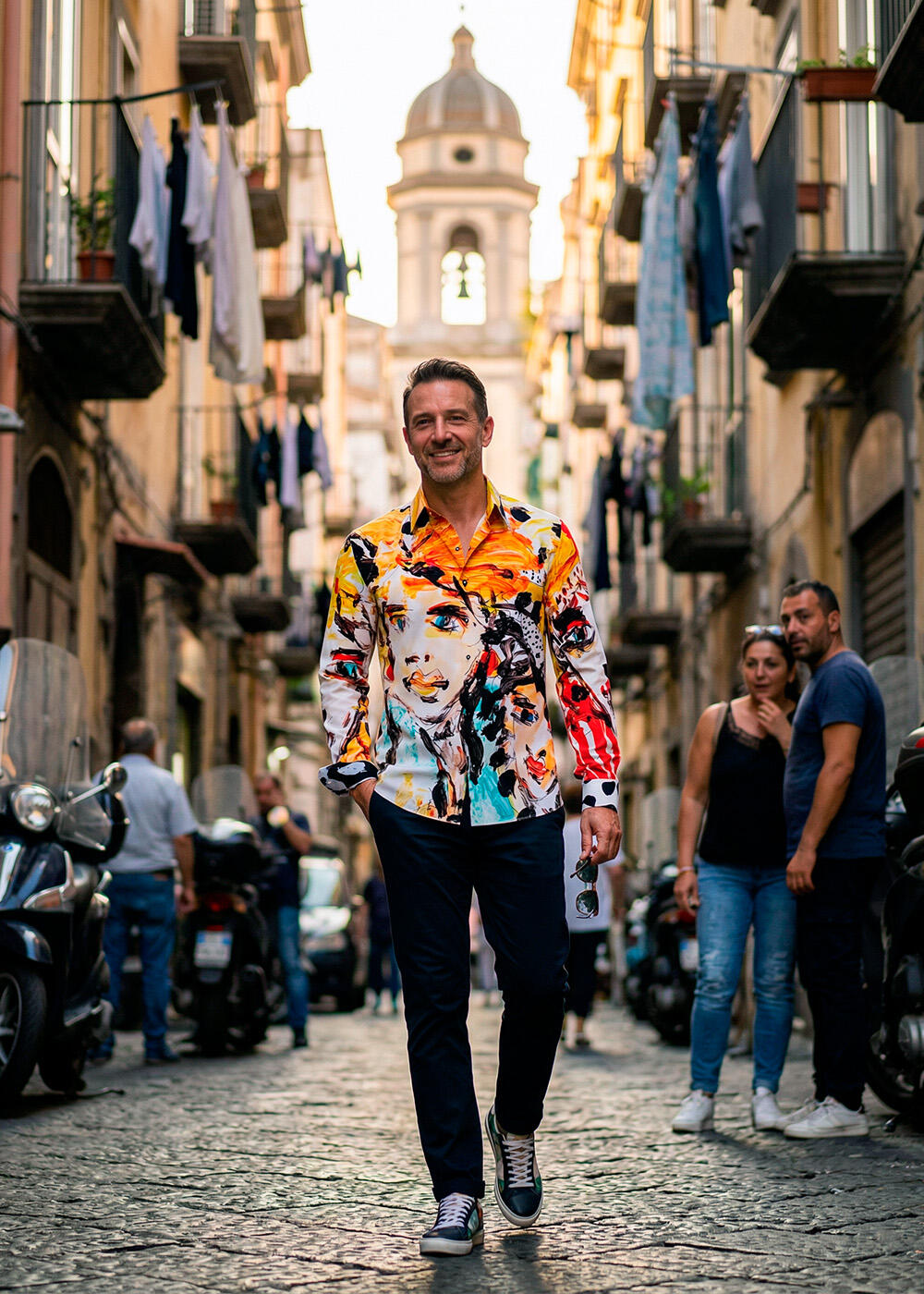 A man strolls through the Italian city of Naples wearing the colorful men's shirt THE BEST GIRL 1 by GERMENS artfashion.