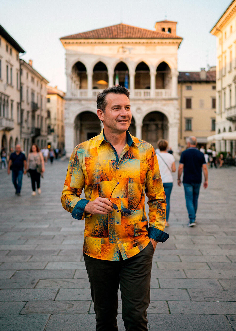 A man is standing on a street in Undine wearing the yellow DRACO GOLD shirt from GERMENS artfashion.
