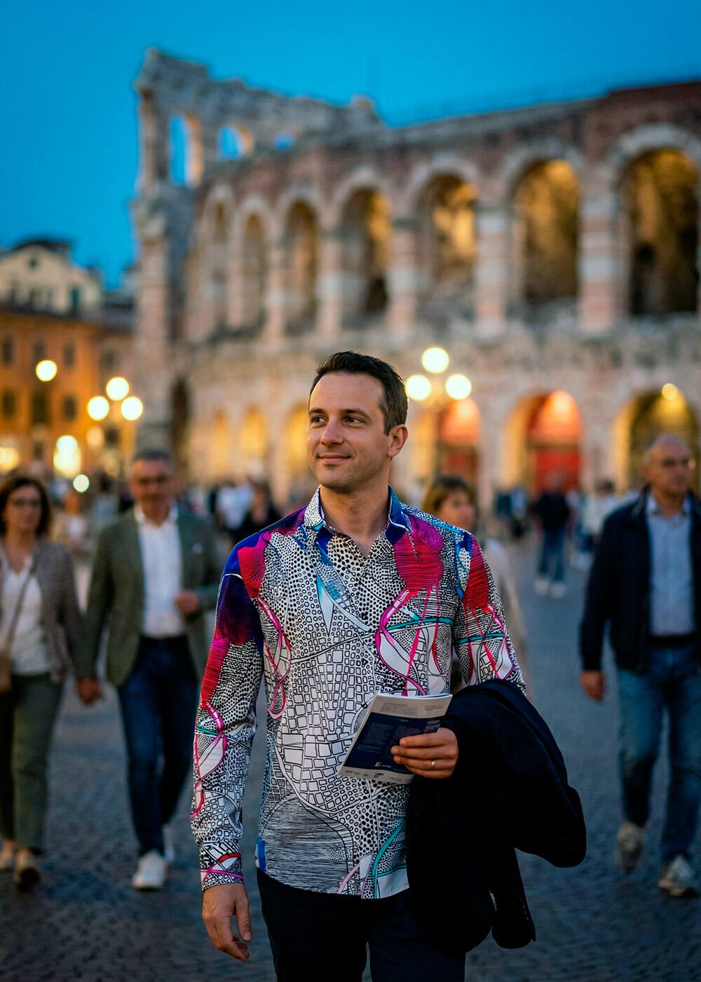 A man walks through Verona wearing the eye-catching QUADROPHONIE shirt by GERMENS artfashion.