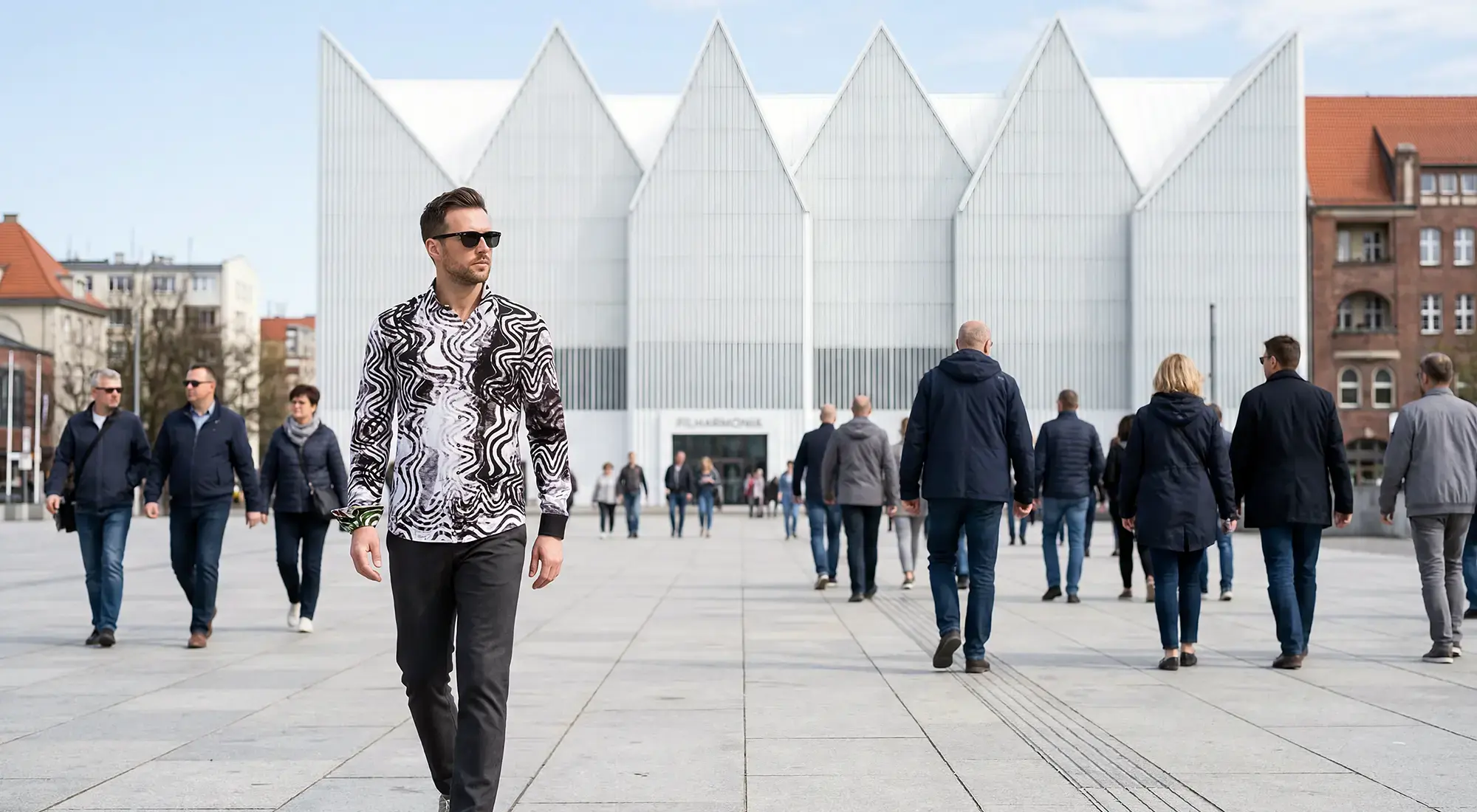 A young man walks through the Polish Baltic Sea city of Szczecin wearing the beautiful GOOD VIBRATIONS shirt by GERMENS.