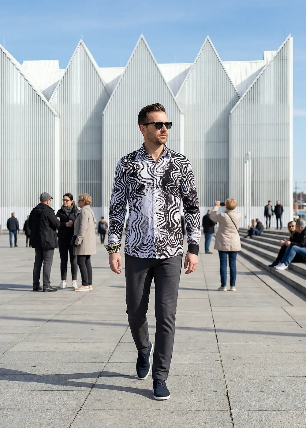 A young man walks through the Polish Baltic Sea city of Szczecin wearing the beautiful GOOD VIBRATIONS shirt by GERMENS.