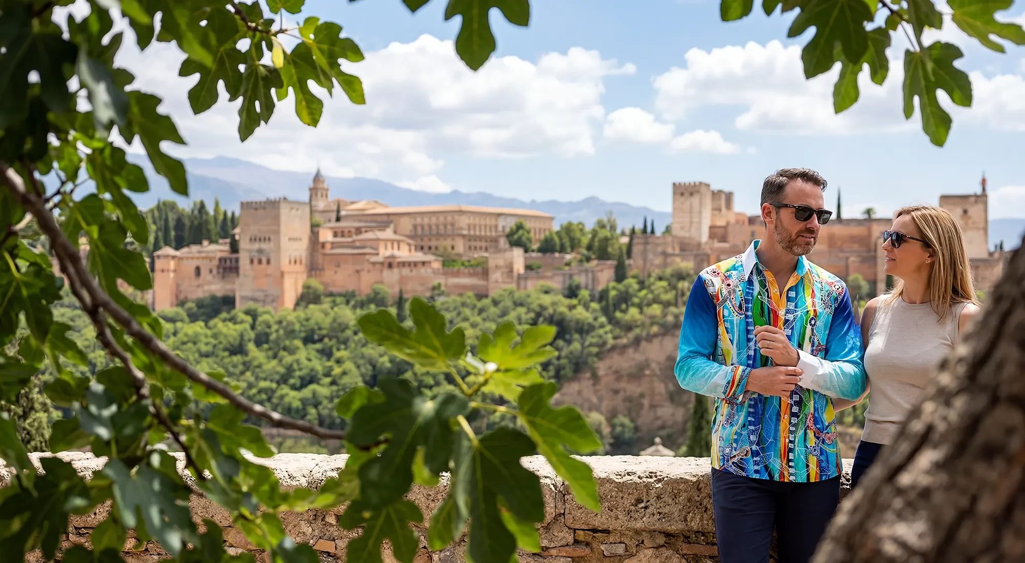 A tourist couple in the Spanish city of Alhambra. The man is wearing the colorful GERMENS COLUMBU shirt.